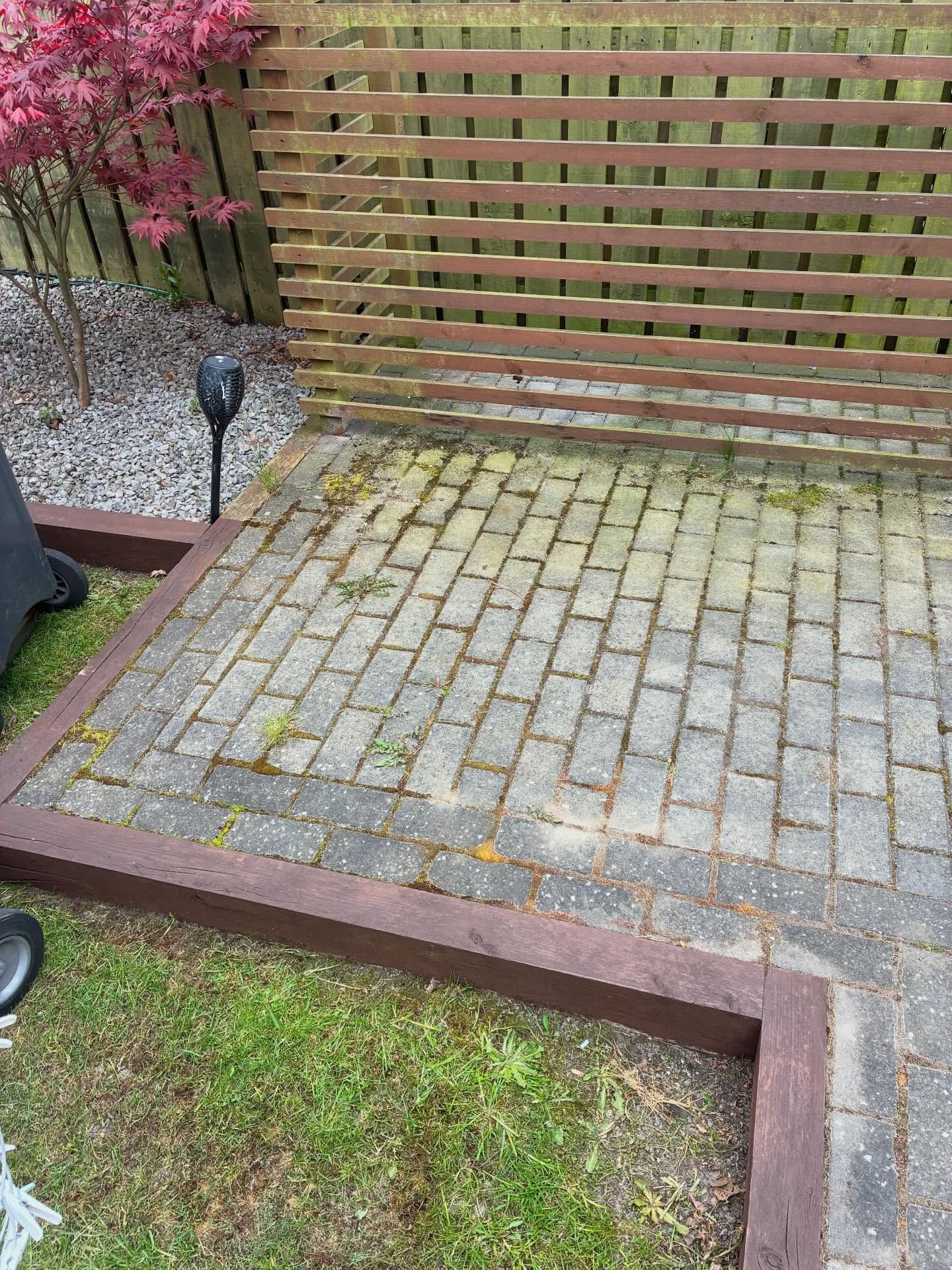 Mossy block paving before a maintenance clean